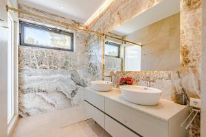 a bathroom with two sinks on a counter at Luxury Seafront Villa Miracul Korcula with Pool in Blato +49 photos