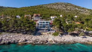 an aerial view of a house on a rocky island at Luxury Seafront Villa Miracul Korcula with Pool in Blato