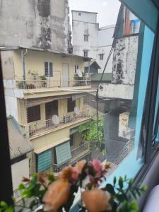 a view of an apartment building from a window at okaeri hotel in Hanoi +17 photos