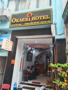 an apartment hotel with a man sitting inside of it at okaeri hotel in Hanoi