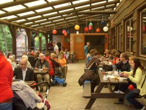 a group of people sitting at tables in a restaurant at Chatová osada Budín u Žirovnice in Žirovnice