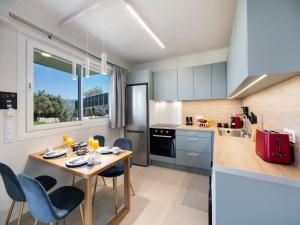 a kitchen with a table and chairs in a kitchen at Asmira Apartments in Lygia