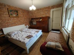a bedroom with a bed and a brick wall at Rodinný dom Cavern - Rajec, 7 km od Rajeckých Teplíc in Rajec