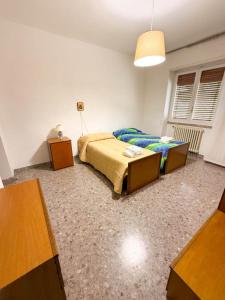 a bedroom with a bed and two tables in it at Casa Vacanze da Francesco in Lettopalena