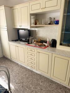 a kitchen with white cabinets and a tv on a counter at Casa Vacanze da Francesco in Lettopalena +13 photos