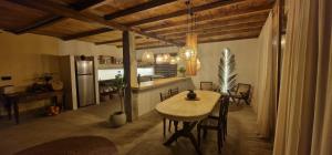 a kitchen and dining room with a table and chairs at Lahima Cabanas Villa in Dickwella