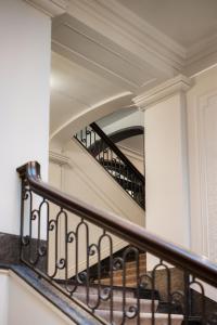 a spiral staircase in a house with a mirror at Grand Hotel Terminus in Bergen +95 photos