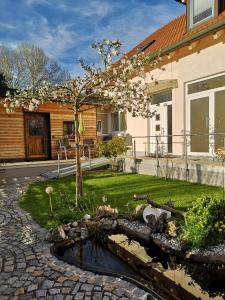 a house with a pond in the yard at Il Giardino in Ilmmünster