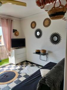 a bedroom with mirrors on the wall and a bed at studio centre plage in Canet-en-Roussillon