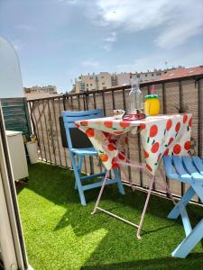 a table and two chairs on a balcony at studio centre plage in Canet-en-Roussillon