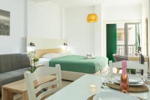 a living room with a bed and a dining room at 4YOU STUDIOS in Larnaca