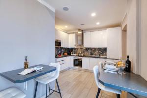 a kitchen with a blue table and white cabinets at Scuderia il Costa in Paratico