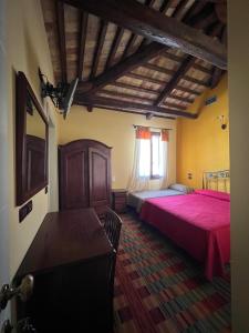 a bedroom with two beds and a table and a window at La Stazione in Cordovado