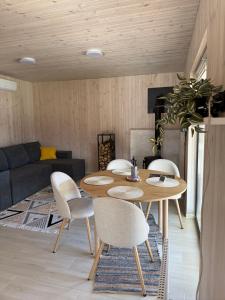 a living room with a table and chairs at Porichka Home in Roslavichi