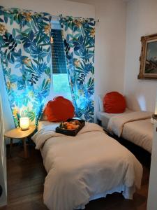 a room with two beds with a tray of fruit on them at como villa il panorama in Como