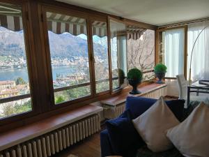 a living room with windows and a view of the water at como villa il panorama in Como