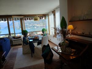 a living room with a table and chairs and a view at como villa il panorama in Como +39 photos