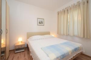 Postel nebo postele na pokoji v ubytování Apartments Surjan