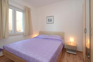 Postel nebo postele na pokoji v ubytování Apartments Surjan