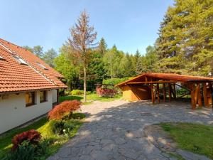 a garden with a pavilion next to a house at Dom pod lesom v Borinke in Stupava