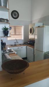 a kitchen with a refrigerator and a counter top at Hibberdene Beachfront Self-Catering 9 Catalina Bay in Hibberdene