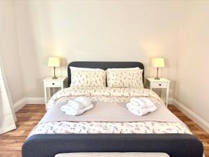 a bedroom with a bed with two towels on it at The Seafarers Rest in Cobh