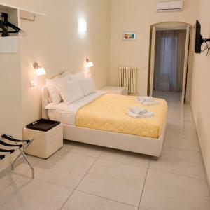 a bedroom with a large bed in a room at Le Gemme Rooms in Matera +32 photos