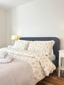 a bed with a white comforter with birds on it at The Seafarers Rest in Cobh +2 photos