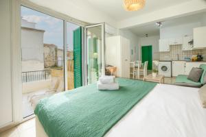 a bedroom with a large bed and a large window at 4YOU STUDIOS in Larnaca