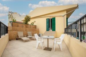 a patio with a table and chairs on a balcony at 4YOU STUDIOS in Larnaca