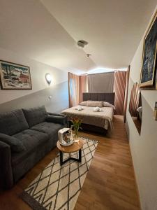 a living room with a couch and a bed at Hotel Villa Neretva - Metković in Metković +46 photos