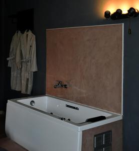 a white bath tub in a bathroom with a towel at Αλώνι - Aloni in Angathiás +18 photos