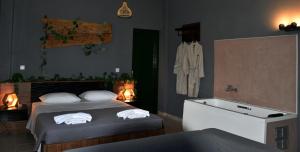 a bedroom with a bed with towels on it at Αλώνι - Aloni in Angathiás