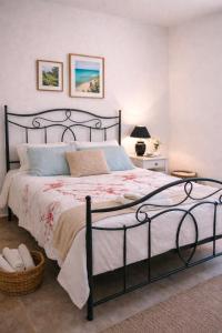 a bedroom with a large bed with a black frame at Emma's HOUSE near beach in Tsakaíoi