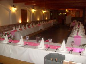 a group of tables with white tablecloths and wine glasses at Chatová osada Budín u Žirovnice in Žirovnice +23 photos