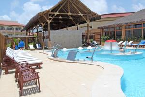a swimming pool with chairs and a resort at Grand Palladium Imbassaí Resort & Spa - All Inclusive in Imbassai