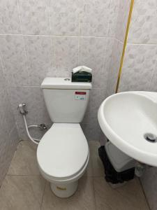 a bathroom with a white toilet and a sink at Hee Pee hostel Buriram in Sathani Buriram +91 photos