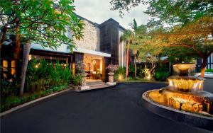 a fountain in the middle of a street in front of a building at The Radiant Hotel & Spa in Kuta