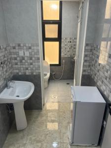 a bathroom with a sink and a toilet at شقق الشموخ in Dammam +18 photos