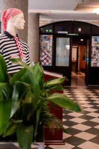 a mannequin wearing a hat and tie in a lobby at Hotel Villa Neretva - Metković in Metković