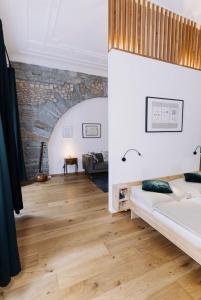 a bedroom with a bed and a brick wall at Larco Trieste studio living 3 in Trieste