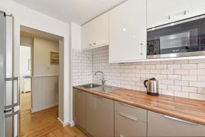 a kitchen with a sink and a counter top at Beach View - East Wittering in Chichester
