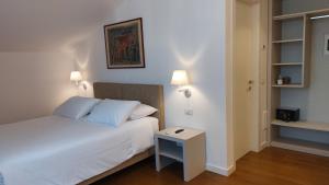 a bedroom with a white bed and a table at SantAgata bed&breakfast in Como