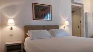 a bedroom with a white bed with two pillows at SantAgata bed&breakfast in Como