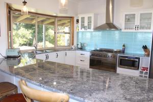 a kitchen with marble counter tops and blue tiles at Montville House on the Hill in Montville