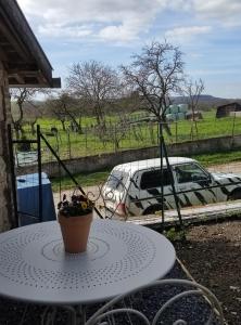 a table with a car parked in a field at Mise au vert in Saint-Juvin