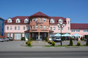 a large pink building with a restaurant in front of it at Weekend in Mukacheve