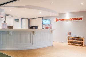 a pharmacy with a counter and a sign on the wall at Résidence Pierre & Vacances Premium Le Domaine de Cramphore in Le Pouliguen +57 photos