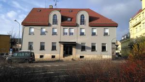 a large white building with a red roof at Hotel Na Baste in Jablonec nad Nisou
