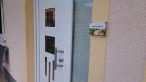 a door with a sign on it next to a building at Monte Baldo in Ilmmünster